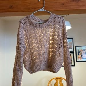 Light pink sweater with baggy sleeves.